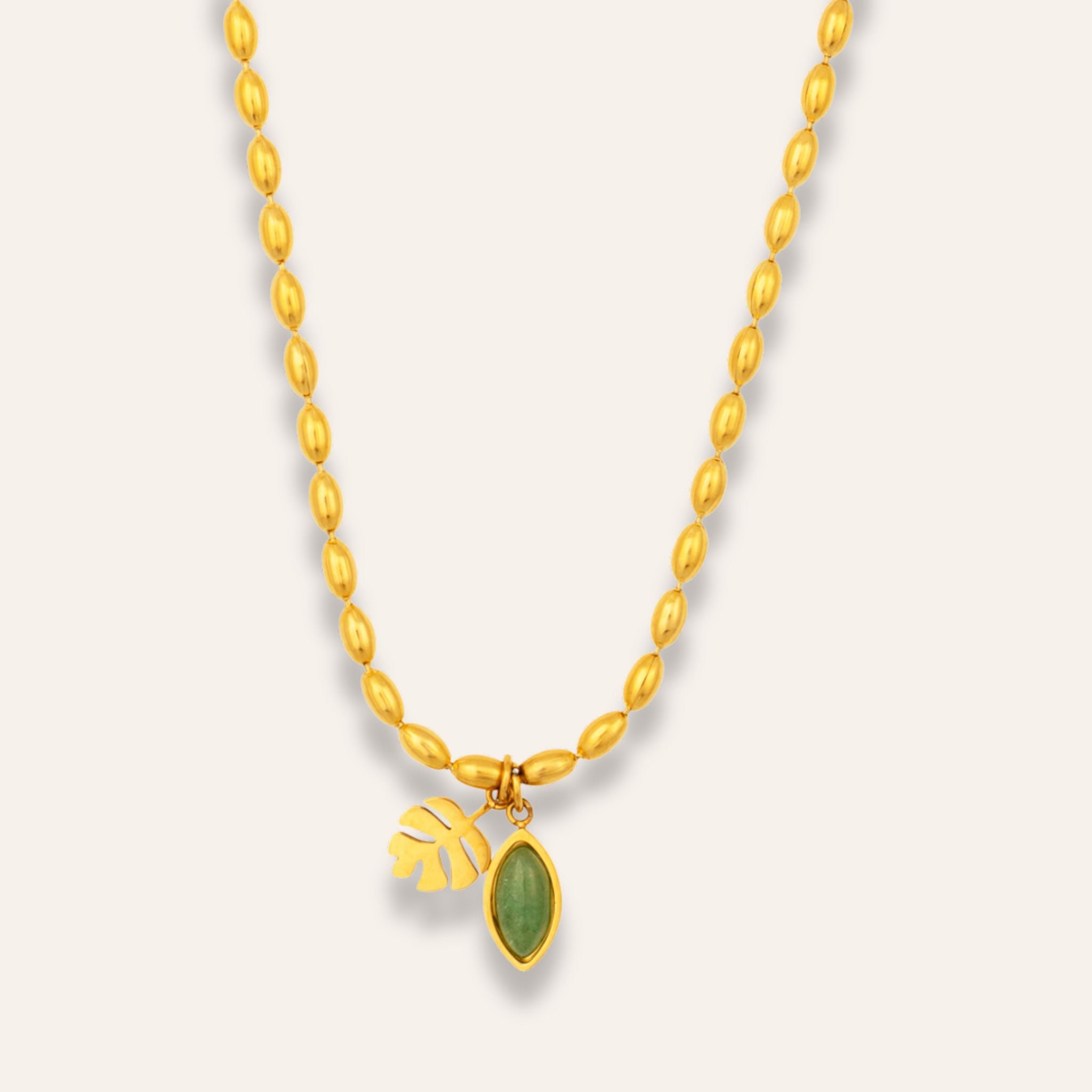 halsband med en grön sten och ett blad